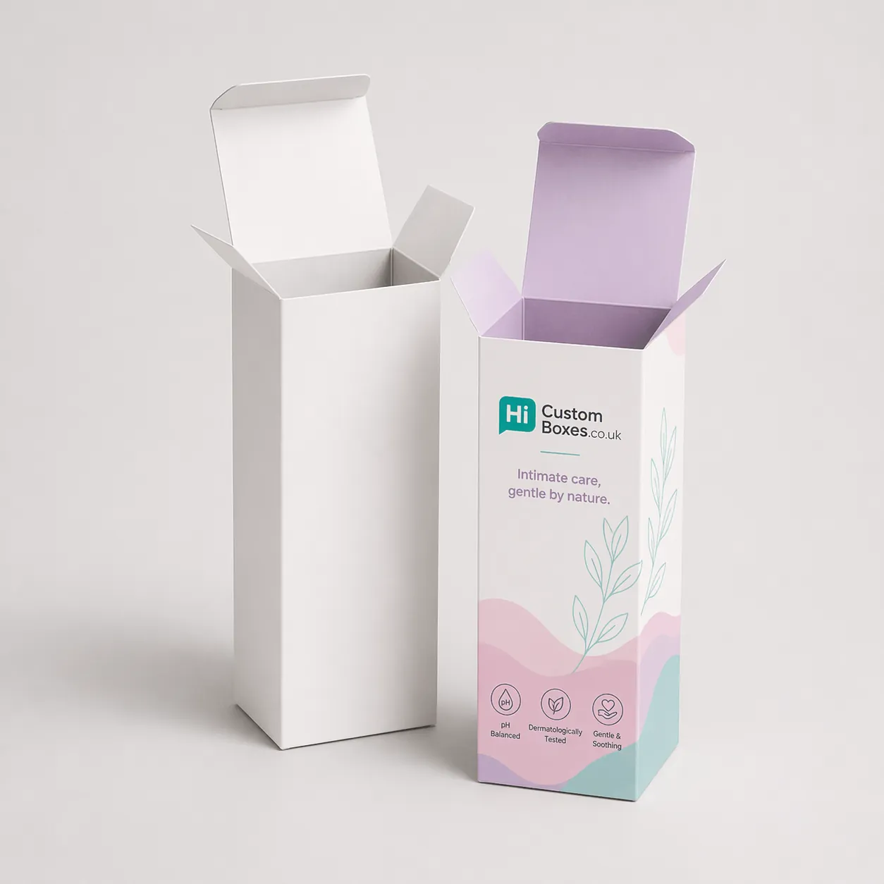 Two vertical cardboard boxes, one blank white and one featuring elegant purple floral product designs.